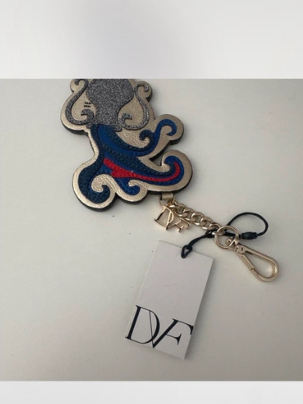 Diane Von Furstenberg Blue, Red & Silver Embossed Keychain Charm Aquarius